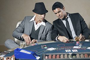 men cheating at a poker table